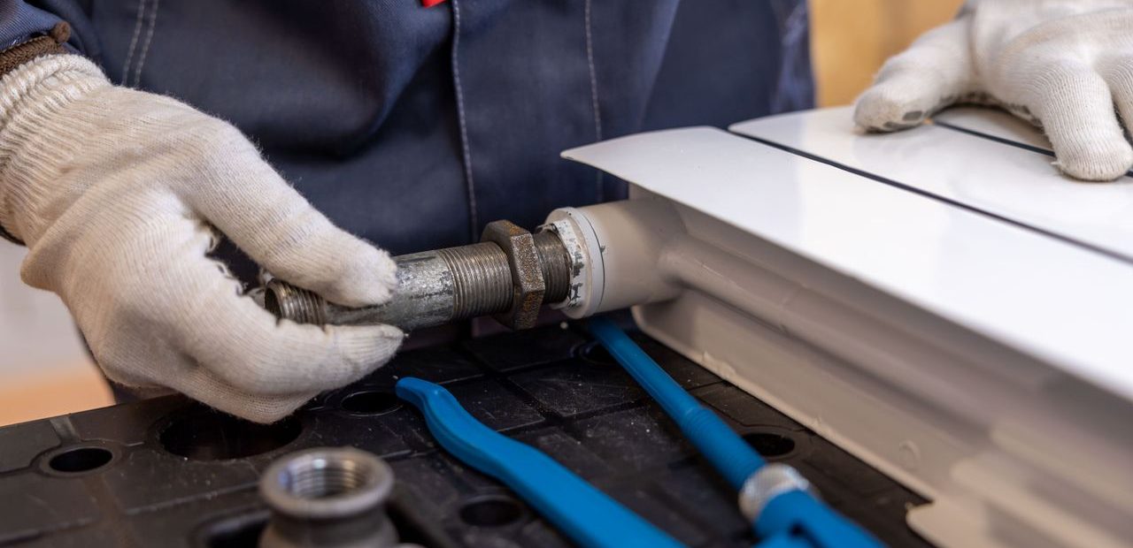 Plumber fitting a radiator valve